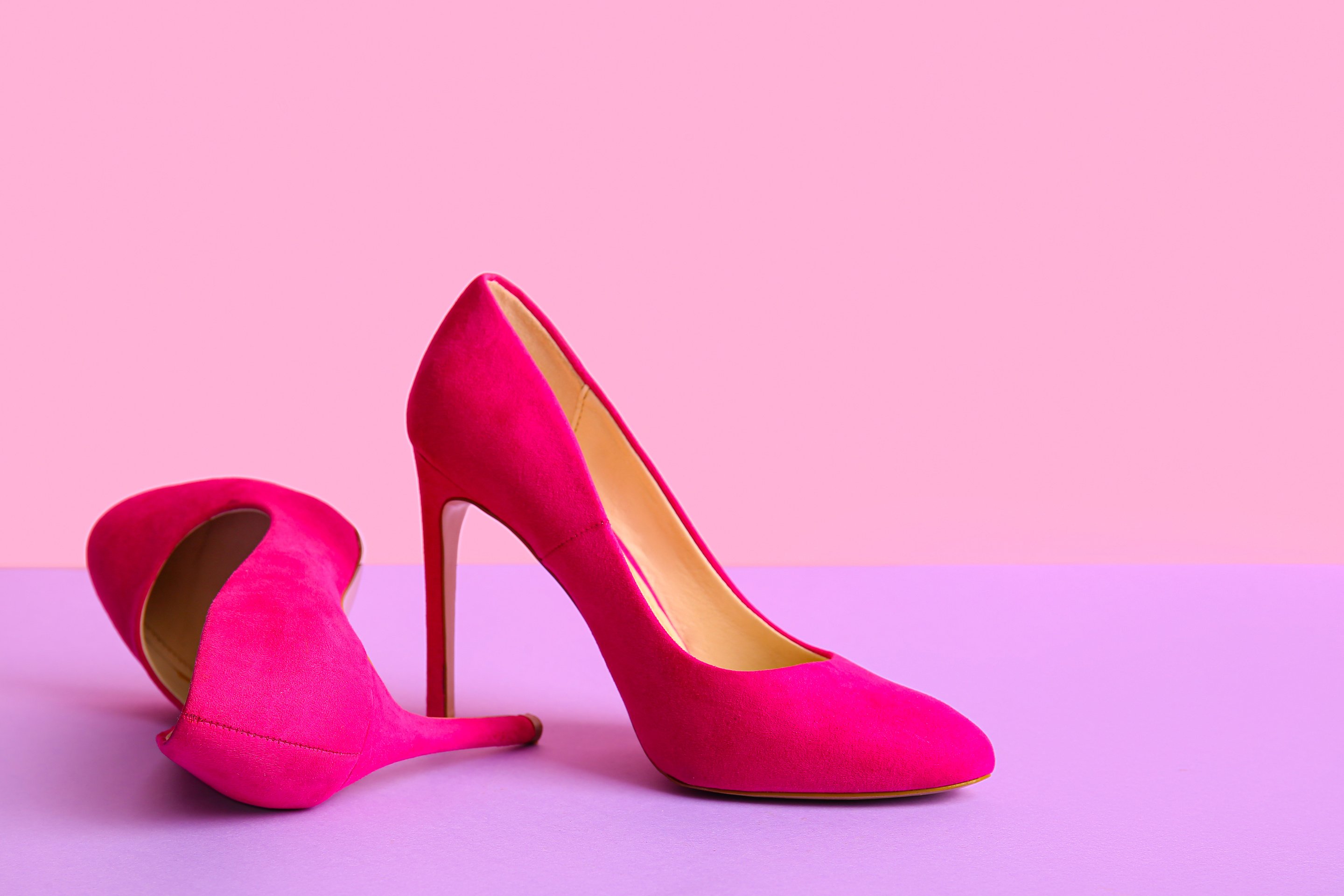 Pair of Stylish High Heeled Shoes on Color Background